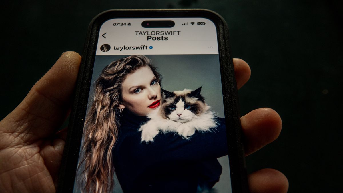 BATH, UNITED KINGDOM - SEPTEMBER 12: In this photo illustration a man looks at the post by Taylor Swift endorsing Democratic Presidential candidate Kamala Harris on the online social media and social networking site Instagram displayed on a smart phone on September 12, 2024 in Bath, England. Taylor Swift posted her support to her 283 million followers with a picture of her holding a cat after the vice president finished her debate with Donald Trump on ABC News.   (Photo by Matt Cardy/Getty Images)