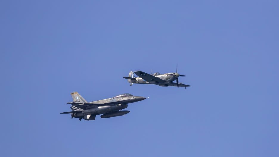 THESSALONIKI, GREECE - OCTOBER 27: A Greek Air Force F-16 jet and Spitfire performing a low pass fly over Thessaloniki city on October 27, 2023 in Thessaloniki, Greece. The national 'Oxi (No) Day' commemorates the rejection by Greek Prime Minister Ioannis Metaxas of the ultimatum made by Italy on 28 October 1940 during World War II. (Photo by Athanasios Gioumpasis/Getty Images)