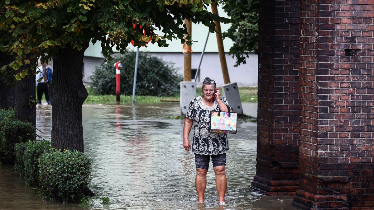 A woman walks in the water after Nysa Klodzka river flooded town of Lewin Brzeski in southwestern Poland, on September 19th, 2024. Storm Boris has caused rivers to burst banks in southern and southwest regions of Poland. Prime Minister of Poland declared a state of natural disaster in affected areas.  (Photo by Beata Zawrzel/NurPhoto via Getty Images)