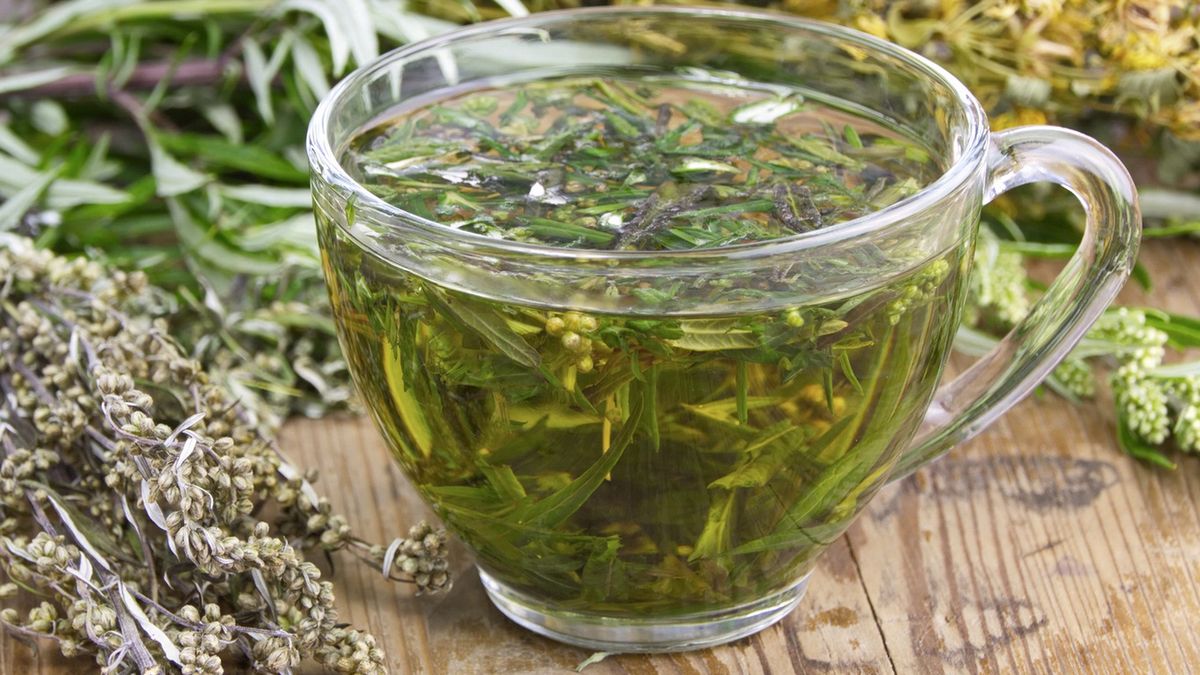 Wormwood bitter (Artemisia absinthium L.) tea drink. Wormwood is used in folk medicine, cooking, perfume industry.Wormwood bitter dried (Artemisia absinthium L.) tea drink. Wormwood is used in folk medicine, cooking, perfume industry.In a glass cup on the wooden surface of the tableNatalia Kuznetsova