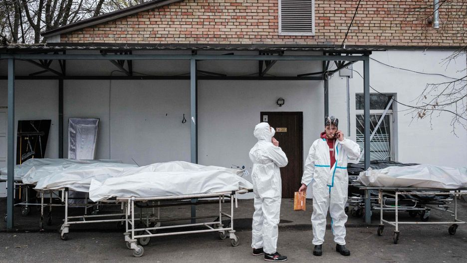 TemporaryWorkers take a break next to body bags as they exam the bodies of victims at a morgue in Bucha, on April 19, 2022, during the Russian invasion of Ukraine. (Photo by Yasuyoshi CHIBA / AFP)YASUYOSHI CHIBA