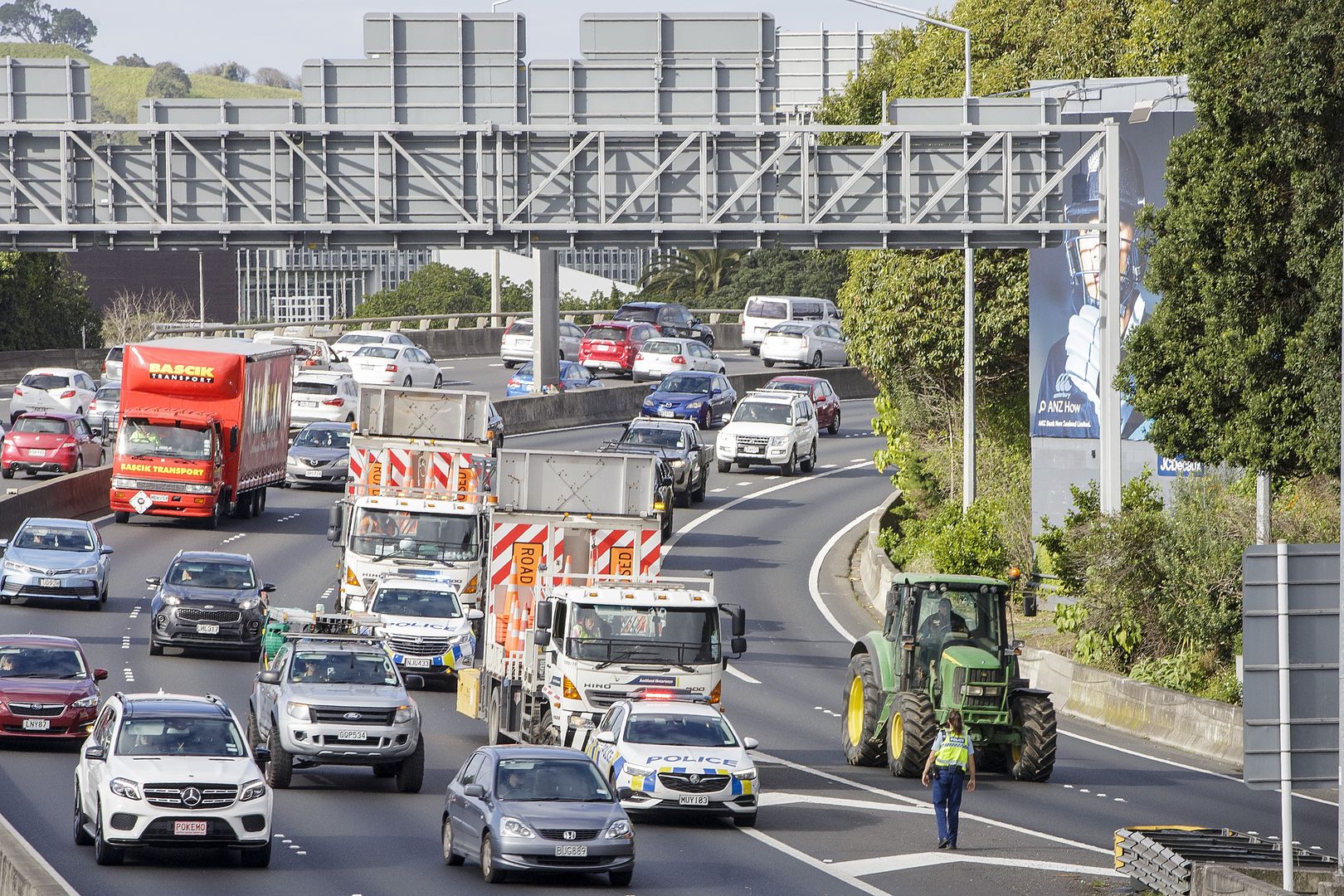 AUCKLAND, NEW ZEALAND - JULY 16: Tractors being driven by farmers and protesters on the motorway into Auckland causing congestion as they express their views on July 16, 2021 in Auckland, New Zealand. Farmers and rural residents are protesting around New Zealand over new government regulations on diesel and higher emission vehicles which has become known as the "ute tax." The NZ Government's Clean Car Package is a rebate scheme aimed at making lower-carbon-emitting cars more affordable while also adding fees on new, higher-emission vehicles, including utes. (Photo by Dave Rowland/Getty Images)