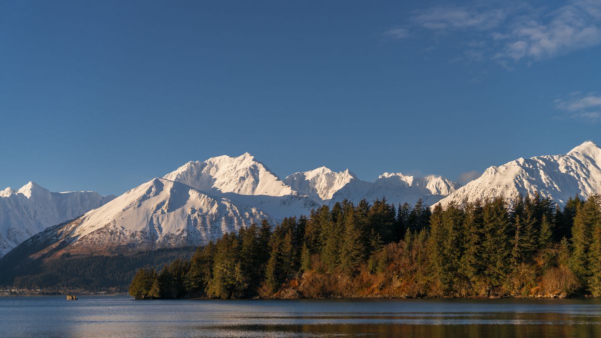 ALASKA, UNITED STATES - DECEMBER 28: A view of the snowy mountains, pine trees and lake of Seward, a port village in Alaska, United States on December 28, 2024. Seward is located on the Resurrection Bay, famous with its fishing culture. (Photo by Hasan Akbas/Anadolu via Getty Images)