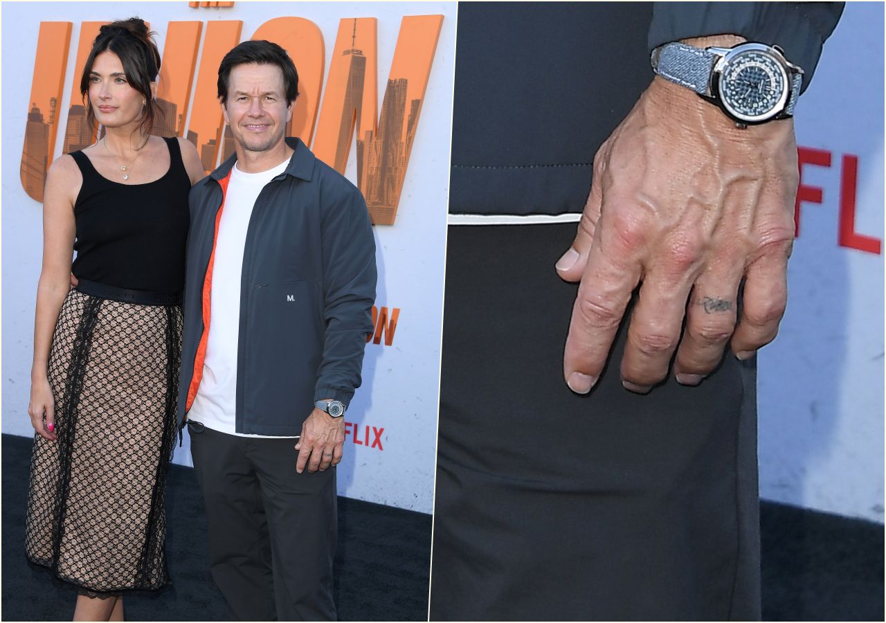 Mark Wahlberg with his wife, a tattoo on his finger visible next to them