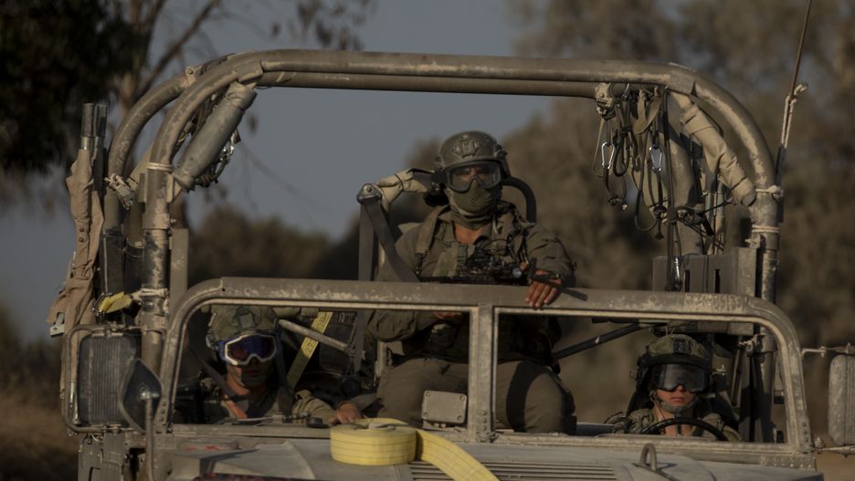 SOUTHERN ISRAEL, ISRAEL - JUNE 24: Israeli soldiers sit on an army vehicle as it is moving near the border with the Gaza Strip on June 24, 2024 in Southern Israel, Israel. In an interview on June 23, Israeli Prime Minister Benjamin Netanyahu said "the intense phase of the fighting against Hamas is about to end," suggesting that the campaign in Rafah would be the last major offensive of the war. But he added, "It doesn't mean that the war is about to end." (Photo by Amir Levy/Getty Images)