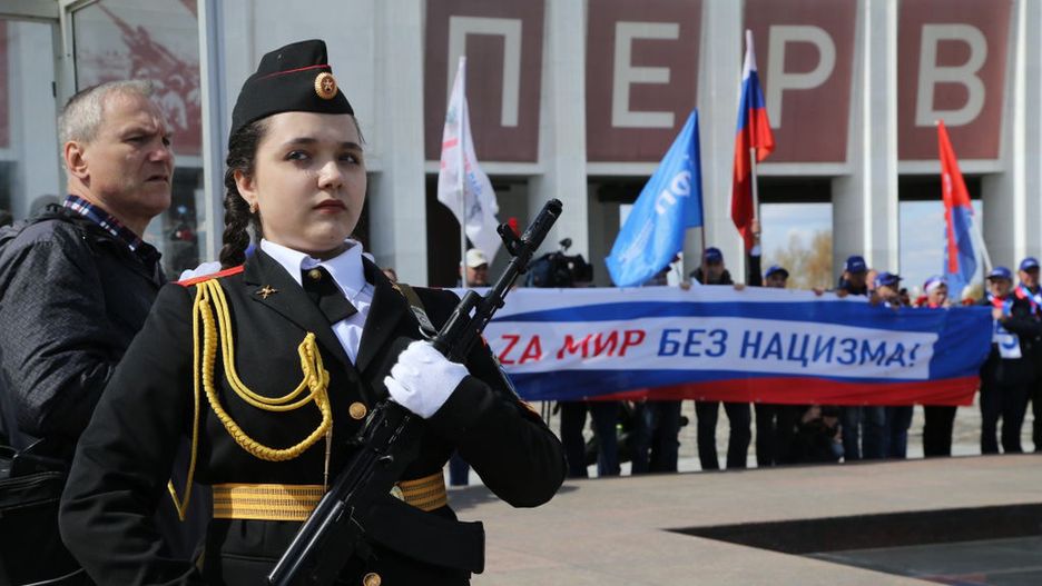 Labour Day Demonstrations In MoscowMOSCOW, RUSSIA - MAY 01: (RUSSIA OUT) A military female cadet with gun machine guards as Federation of Independent Trade Unions of Russia's activists hold a poster with "Z" letter, during the rally marking the Labour Day on May 1, 2022 in Moscow, Russia. Russian trade unions and communists mark the International Workers Day, also known as Labour Day across the country, as a Soviet tradition and to support Vladimir Putin's military operation in Ukraine. (Photo by Konstantin Zavrazhin/Getty Images)Konstantin Zavrazhin