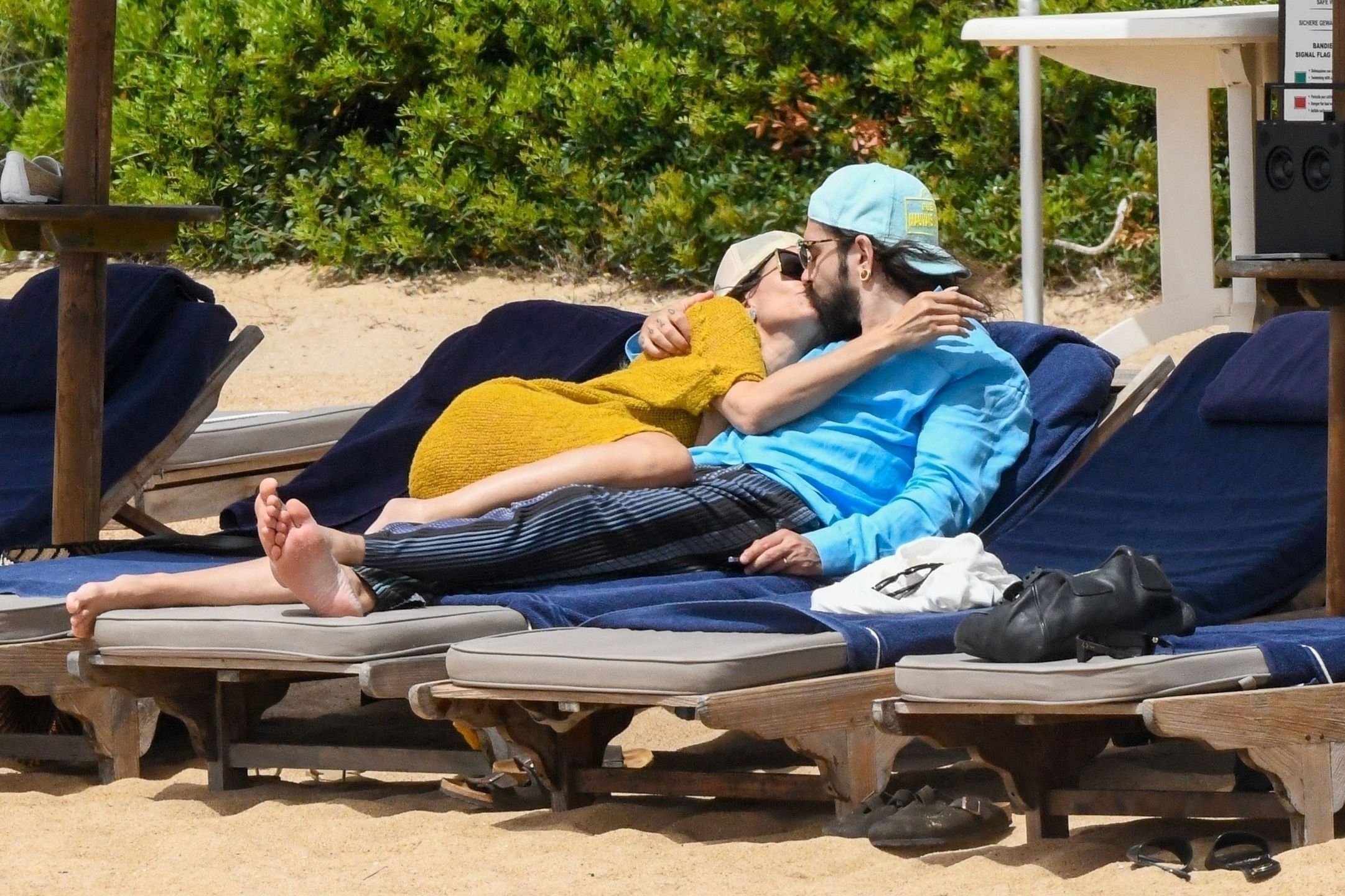 *PREMIUM-EXCLUSIVE* MUST CALL FOR PRICING BEFORE USAGE  - Love is All Around for Heidi Klum and her husband Tom Kaulitz as they set the temperatures soaring along with Heidi's daughter Leni and her boyfriend Aris Rachevsky during their sizzling hot family
*PREMIUM-EXCLUSIVE* Sardinia, ITALY  - MUST CALL FOR PRICING BEFORE USAGE  - Heidi Klum and her husband Tom Kaulitz turn up the temperatures out on their sun-soaked holiday out in Sardinia.

51-year old Heidi, the German-American model and television host looked stunning in her skimpy little bikini set as she took in the rays, slapping on the sun cream.

Heidi and Tom showed off their undying love for one another, packing on the PDA with a few kisses sprawled out on their sun beds on their family trip.

Accompanying the loved up couple was Heidi's daughter Leni Klum showing off her svelte figure in the hot Sardinian sunshine seen with her boyfriend Aris Rachevsky along with the kids, Johan and Henry.

It would seem love is in the air also for Leni as she too packed on the PDA with a rather hot display out on the beach with a few hugs and kisses as Aris took a few snaps of his girl during the European family getaway.

*Pictures Containing Children Please Pixelate Face Prior To Publication*,Image: 883521781, License: Rights-managed, Restrictions: RIGHTS: WORLDWIDE EXCEPT IN ARGENTINA, AUSTRIA, FRANCE, GERMANY, ITALY, MEXICO, PORTUGAL, SPAIN, SWITZERLAND, Model Release: no, Pictured: Heidi Klum, Credit line: COBRA TEAM - FREZZA LAFATA / BACKGRID / Backgrid UK / Forum
COBRA TEAM - FREZZA LAFATA / BACKGRID / Backgrid UK / Forum
Heidi Klum, Tom Kaulitz, daughter, holiday, beach, vacation, sunbathing, mum, mother, relaxing, Leni Olumi Klum, boyfriend, PDA, oversized sunglasses, happy, laughing, bikini, cleavage, floral bikini, flower print bikini, heart gold necklace, shopping, thong bikini, kiss, kissing, topless, braless, green beach dress, kaftan dress, see through, cap, tote bag, beach bag, shorts, black vest, jewellery, family holiday, green dress, yellow dress
