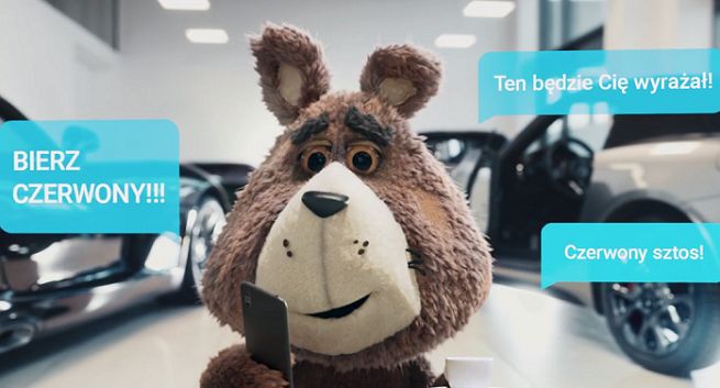 Plushak w salonie samochodowym reklamuje Plush na Kartę z etui do smartfonów (wideo)