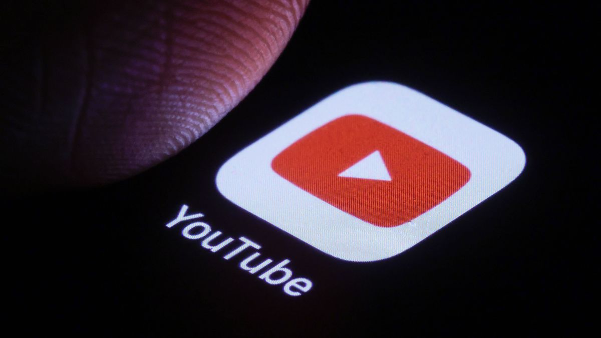 BERLIN, GERMANY - JANUARY 03: In this photo illustration the logo of YouTube can be seen next to a finger on a smartphone on January 03, 2025 in Berlin, Germany. (Photo Illustration by Thomas Trutschel/Photothek via Getty Images)