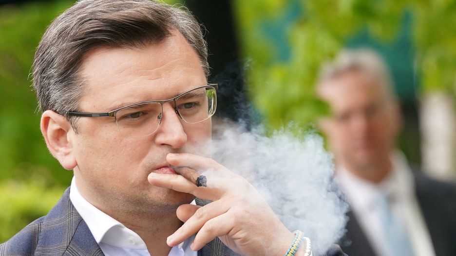 Ukraine's Foreign Minister Dmytro Kuleba smokes a cigar during a break at the G7 Foreign Ministers Summit in Weissenhaeuser Strand, Germany, May 13, 2022