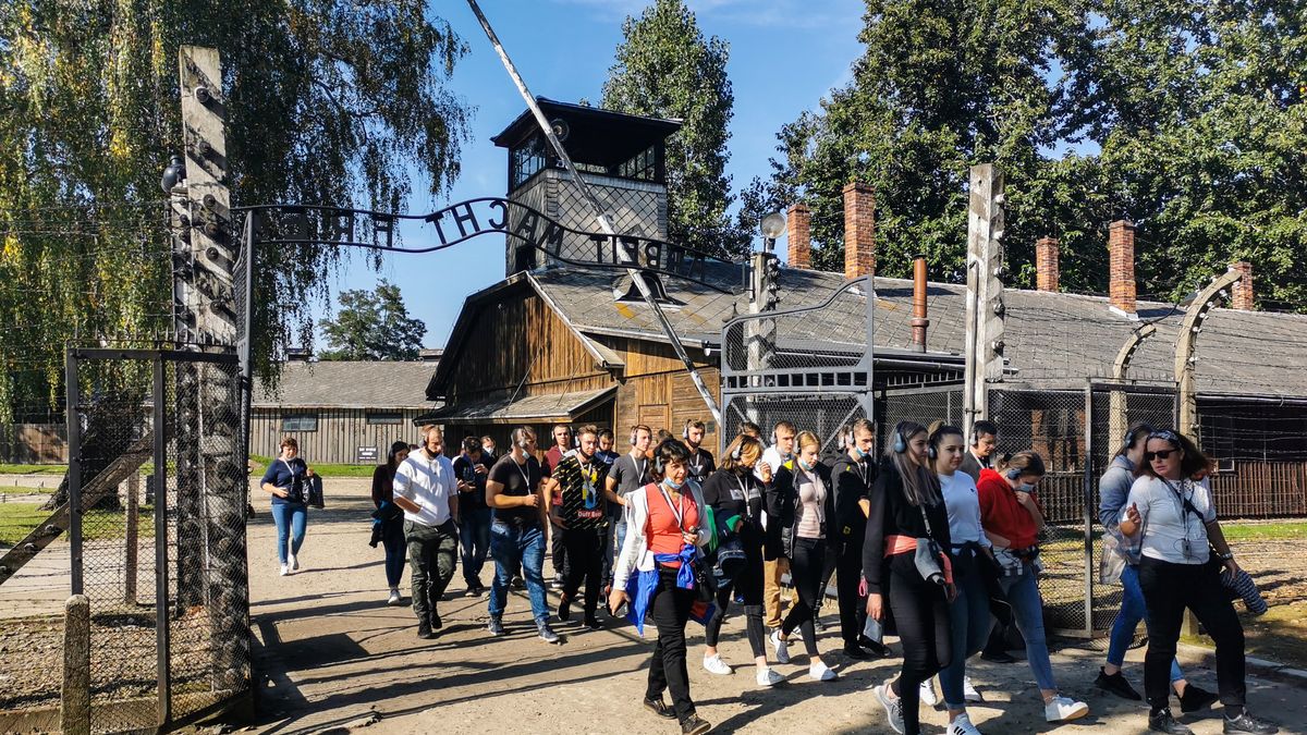 Visitors walk through the entrance gate with 'Arbeit Macht Frei' inscription in the former Nazi German Auschwitz I concentration camp at Auschwitz Memorial Site. Oswiecim, Poland on October 4, 2021.   (Photo by Beata Zawrzel/NurPhoto via Getty Images)