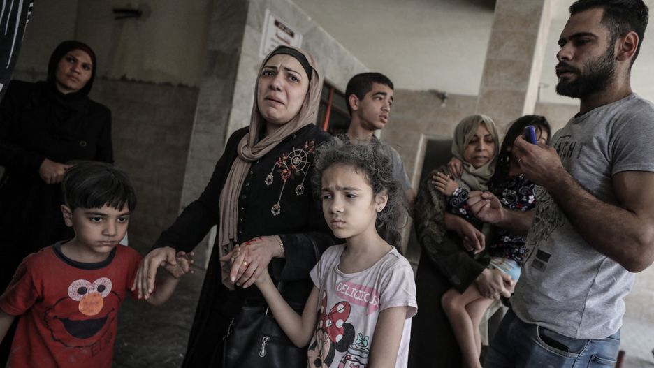 GAZA CITY, GAZA - MAY 11:  Palestinians evacuate a building targeted by Israeli warplanes conducting airstrikes in various parts of Gaza Strip, in Gaza City, Gaza on May 11, 2021. (Photo by Ali Jadallah/Anadolu Agency via Getty Images)