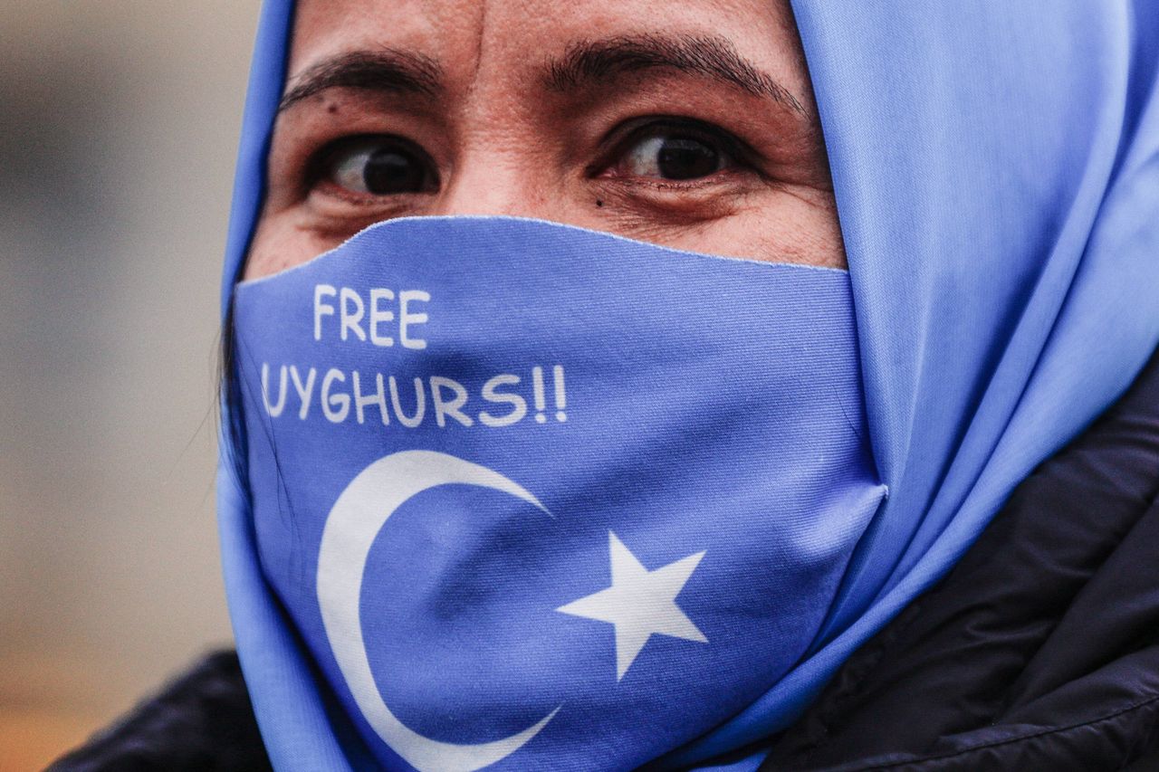 An Uyghur woman attends a demonstration against Beijing 2022 Winter Olympic Games in Berlin, Germany, 04 January 2022 