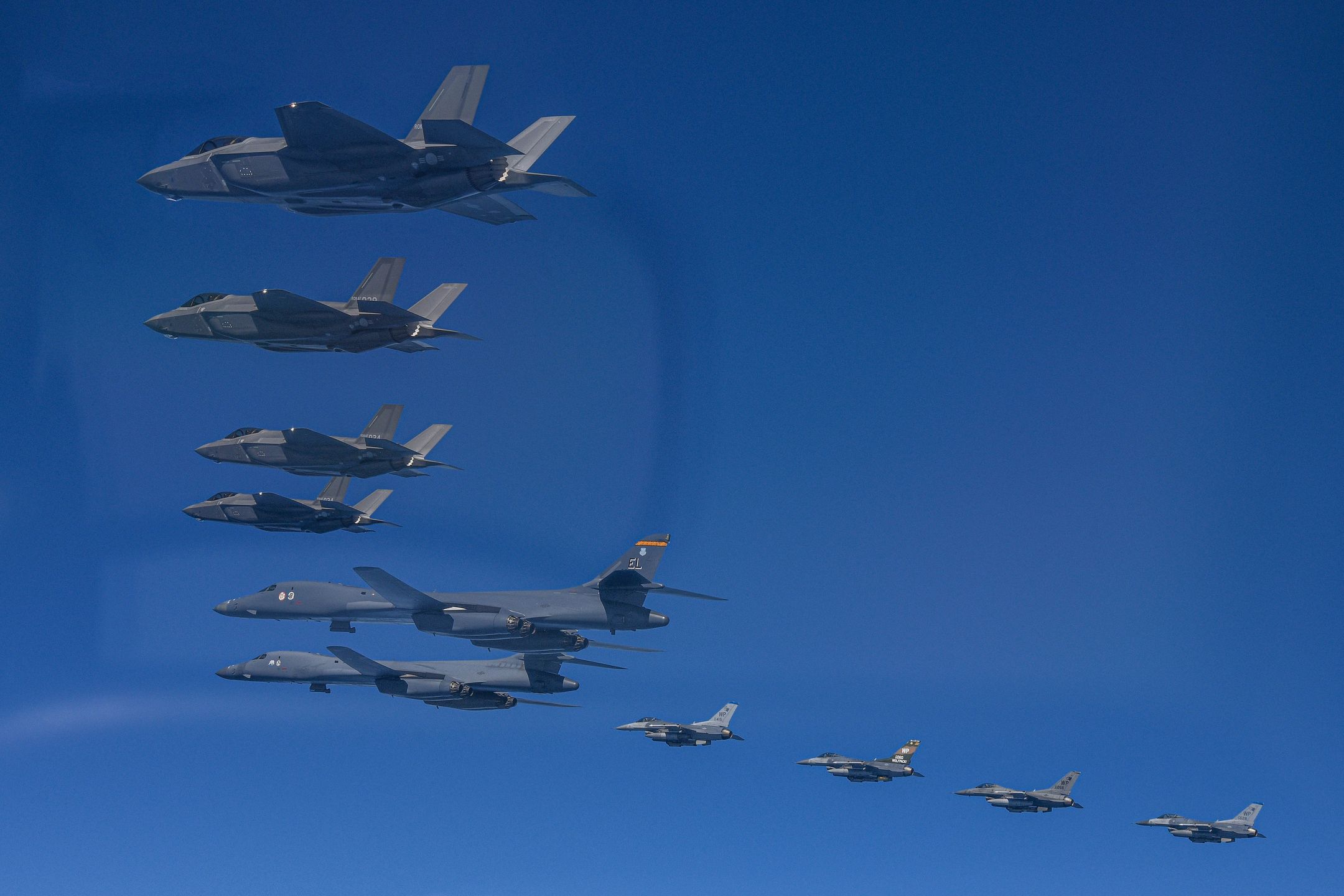 UNDISCLOSED LOCATION, SOUTH KOREA - MARCH 19: In this handout image released by the South Korean Defense Ministry, two US Air Force B-1B bombers (C) flying over South Korea with South Korean Air Force F-35A (top L) and US Air Force F-16 (bottom) fighter jets during a combined air drill on March 19, 2023 at an undisclosed location in South Korea. U.S. B-1B strategic bomber returned to South Korea for combined exercises as North Korea fired yet another ballistic missile into the East Sea, according to the defense ministry. (Photo by South Korean Defense Ministry via Getty Images)