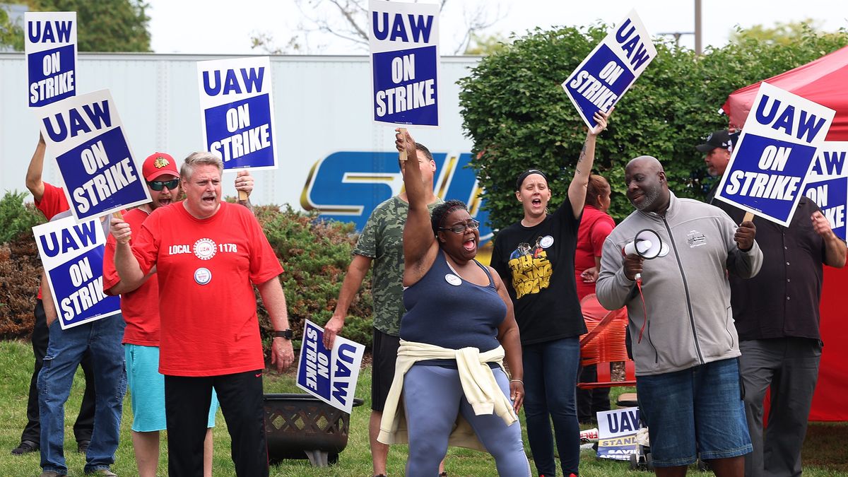 Front row from left , Brian Conklin, Veronica Harmon and Eric Thomas, bring enthusiasm to the picket line outside the Chrysler MOPAR Parts Distribution Center on Friday, Sept. 22, 2023, in Naperville, Illinois. (Stacey Wescott/Chicago Tribune/Tribune News Service via Getty Images)