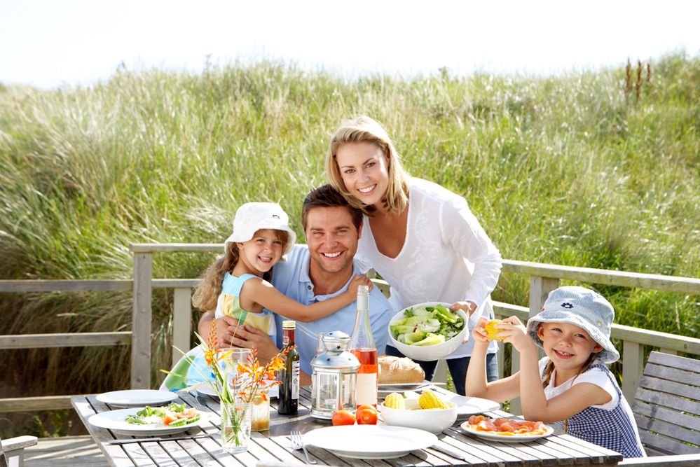 Back view of a happy family on tropical beach