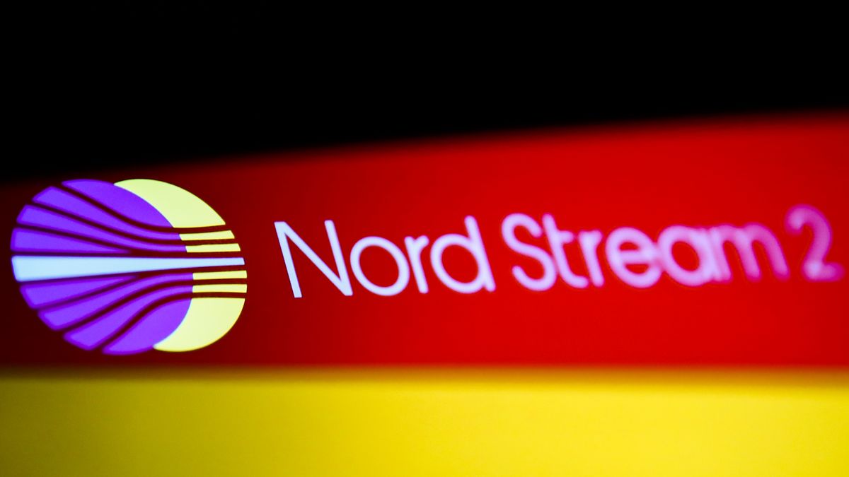 Nord Stream 2 logo displayed on a phone screen and German flag displayed on a laptop screen are seen in this multiple exposure illustration photo taken in Krakow in Krakow, Poland on February 22, 2022. (Photo illustration by Jakub Porzycki/NurPhoto via Getty Images)