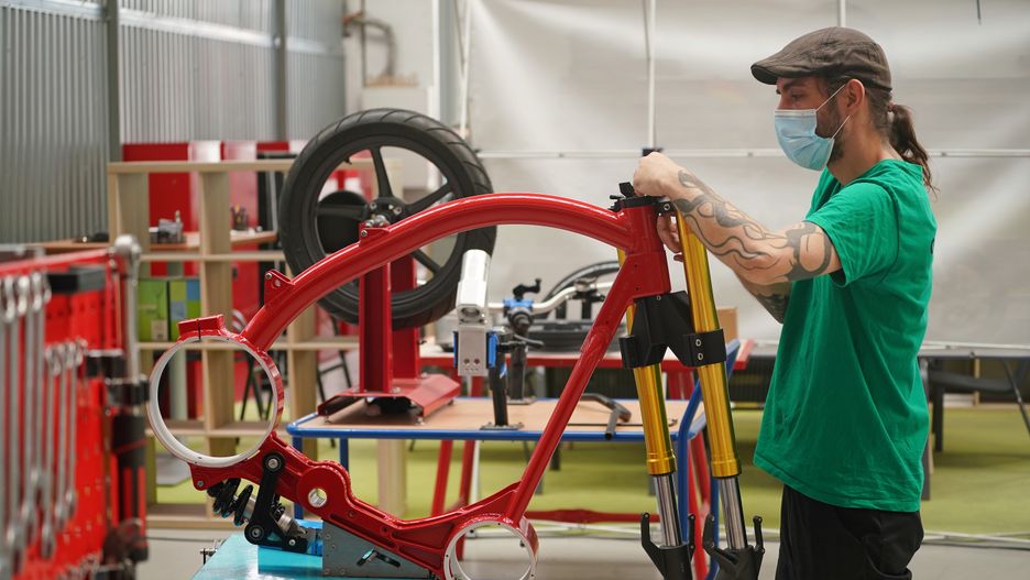 BERLIN, GERMANY - AUGUST 25: A worker assembles an eRockit pedal-powered electric motorcycle at the eRockit production facility near Berlin during the coronavirus pandemic on August 25, 2020 in Hennigsdorf, Germany. eRockit is a local start-up producing the bikes with orders and sales expected to reach three figures this year. (Photo by Sean Gallup/Getty Images)
