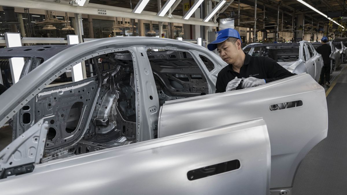 NINGBO, CHINA - MAY 29: A worker assembles a car frame on the production line for electric vehicle maker Zeekr at its factory on May 29, 2025 in Ningbo, China. China's automakers account for nearly two-thirds of global sales of electric vehicles and exports more vehicles overseas than any other country. Zeekr, a pure-electric brand aimed at the luxury market, has seen sales growth in the highly competitive Chinese market and is furthering its expansion into Asia, the Middle East, Latin America, and parts of Europe. The company's plans to enter the US market has faced hurdles due to tariffs on China made electric vehicles. In 2024, Zeekr delivered more than 220,000 vehicles, according to the company. Zeekr is among several Chinese EV makers building vehicles in automated factories using robotics powered by artificial intelligence alongside human workers. Zeekr is owned by Geely Holdings, which also has ownership stake in a number of foreign brands including Volvo, Lotus, and Polestar. (Photo by Kevin Frayer/Getty Images)