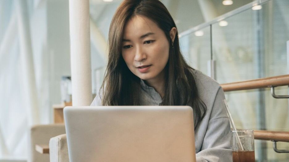 Asian woman working in cafe