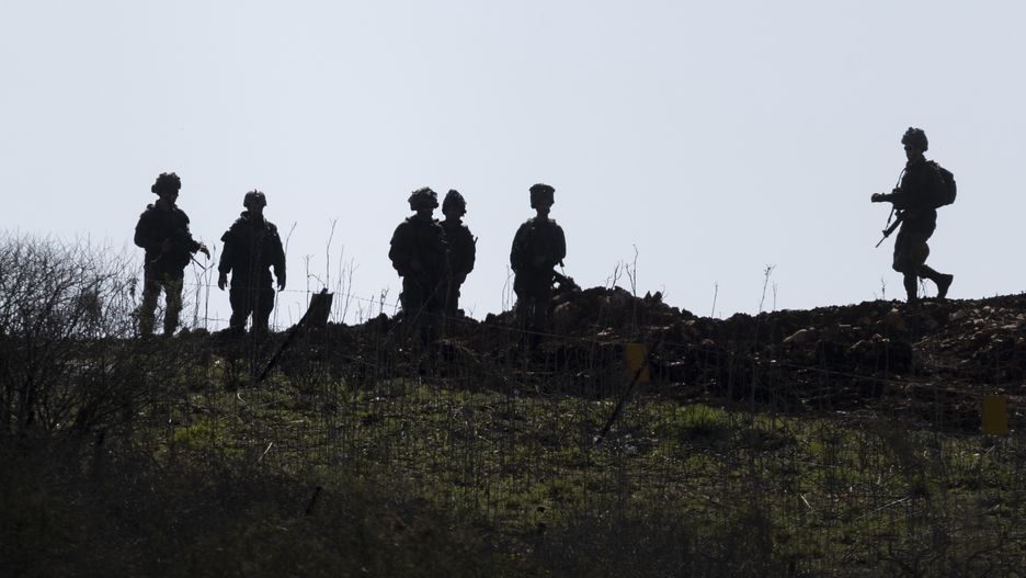 NORTHERN LEBANON, ISRAEL - FEBRUARY 18: Israeli soldiers walk at the buffer zone between Northern Israel and Southern Lebanon as seen from a position on the Israeli side of the border on February 18, 2025 in Northern Israel, Israel. Despite troops withdrawal from Southern Lebanon, Israeli military remain at five Southern Lebanese posts. (Photo by Amir Levy/Getty Images)