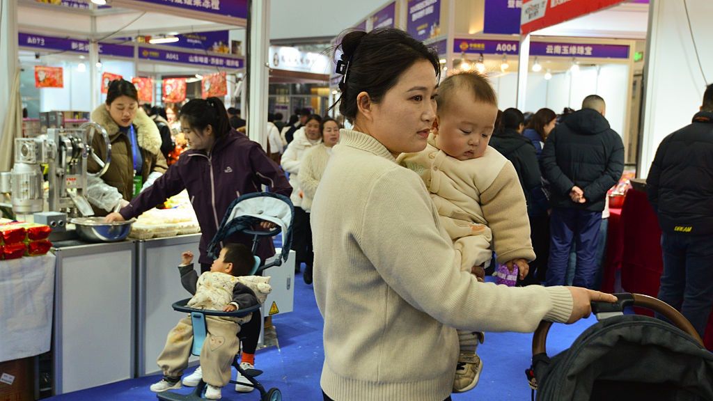 A mother carries her baby while pushing a stroller as she
FUYANG CITY, ANHUI PROVINCE, CHINA - 2026/01/16: A mother carries her baby while pushing a stroller as she walks through the busy aisles of the Fuyang Spring Festival shopping fair. (Photo by Sheldon Cooper/SOPA Images/LightRocket via Getty Images)
SOPA Images
fuyang spring festival, woman, daily life, stroller, shopping fair