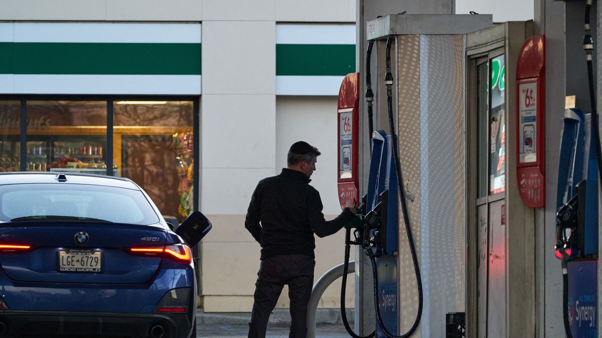 A driver refuels a vehicle at an Exxon gas station in Elizabeth, New Jersey, US, on Monday, March 9, 2026. President Donald Trump said he would waive oil-related sanctions, have the US Navy escort tankers through the Strait of Hormuz and predicted on Monday that the war with Iran would resolve "very soon" as he confronted mounting economic and political pressure and days of dramatic fluctuations in oil markets. Photographer: Bing Guan/Bloomberg via Getty Images