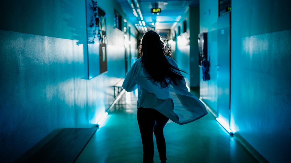 Panic female doctor rushing down a hospital corridor
Rear view of female doctor rushing down the corridor of the hospital ward
SimonSkafar