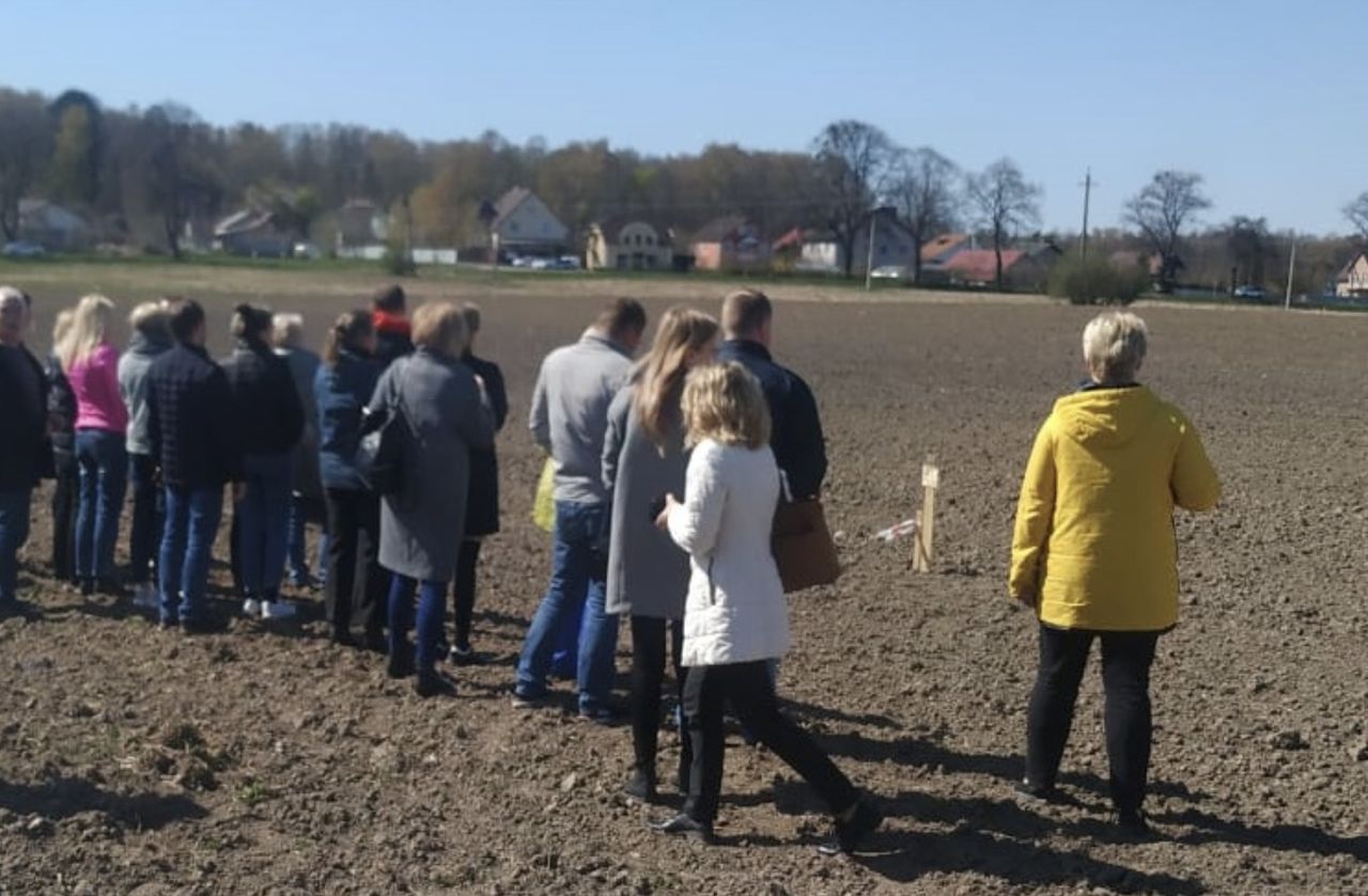 Pracownicy Awtotoru oglądają teren, przeznaczony pod warzywne działki. Będą je uprawiać na przymusowym urlopie 