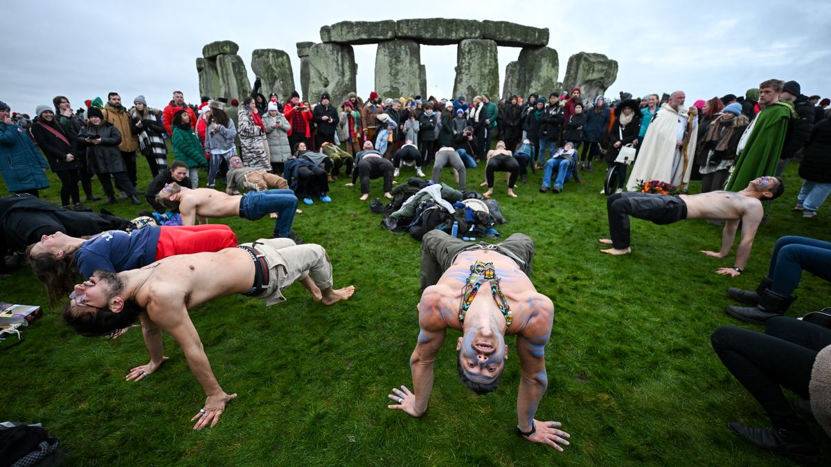 WILTSHIRE, ENGLAND - DECEMBER 21: Visitors celebrate the Winter Solstice at Stonehenge on December 21, 2024 in Wiltshire, England. The winter solstice, which occurs around December 21st each year, marks the shortest day and longest night of the year. (Photo by Finnbarr Webster/Getty Images)