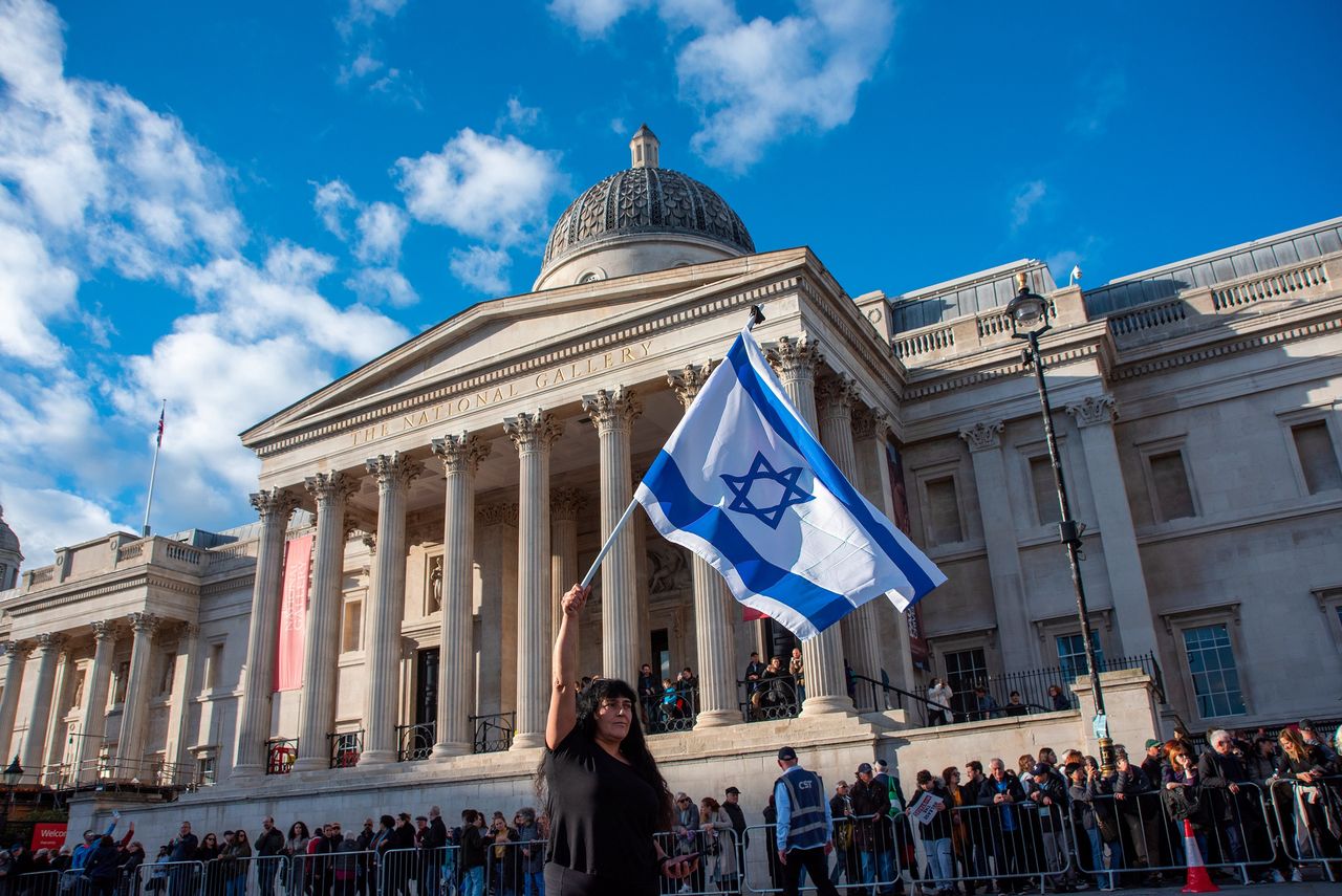 A protester waves an Israeli flag infront of the National Gallery in London