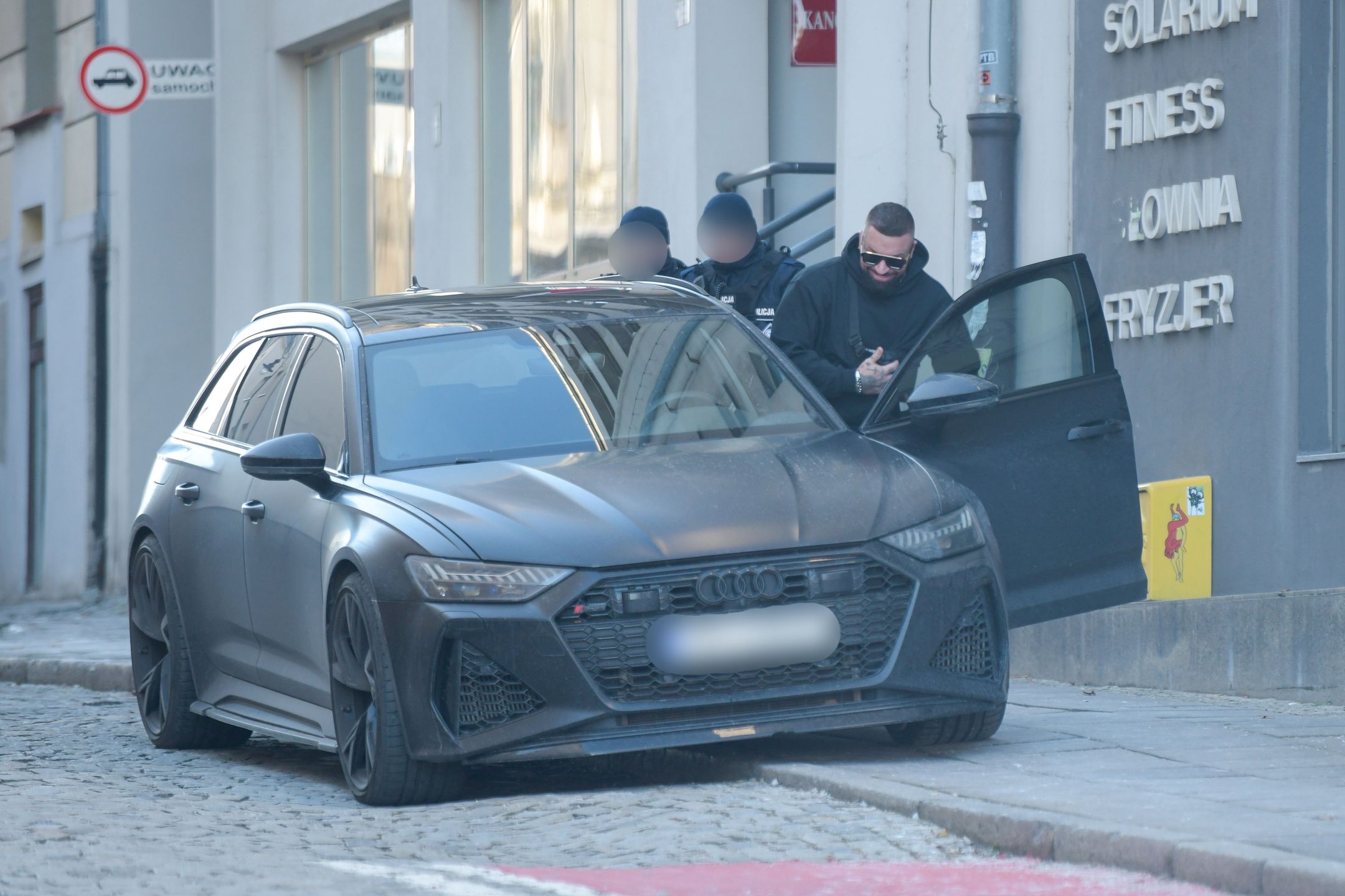 Uśmiechnięty Daniel Majewski wsiada do samochodu za ponad 600 tysięcy