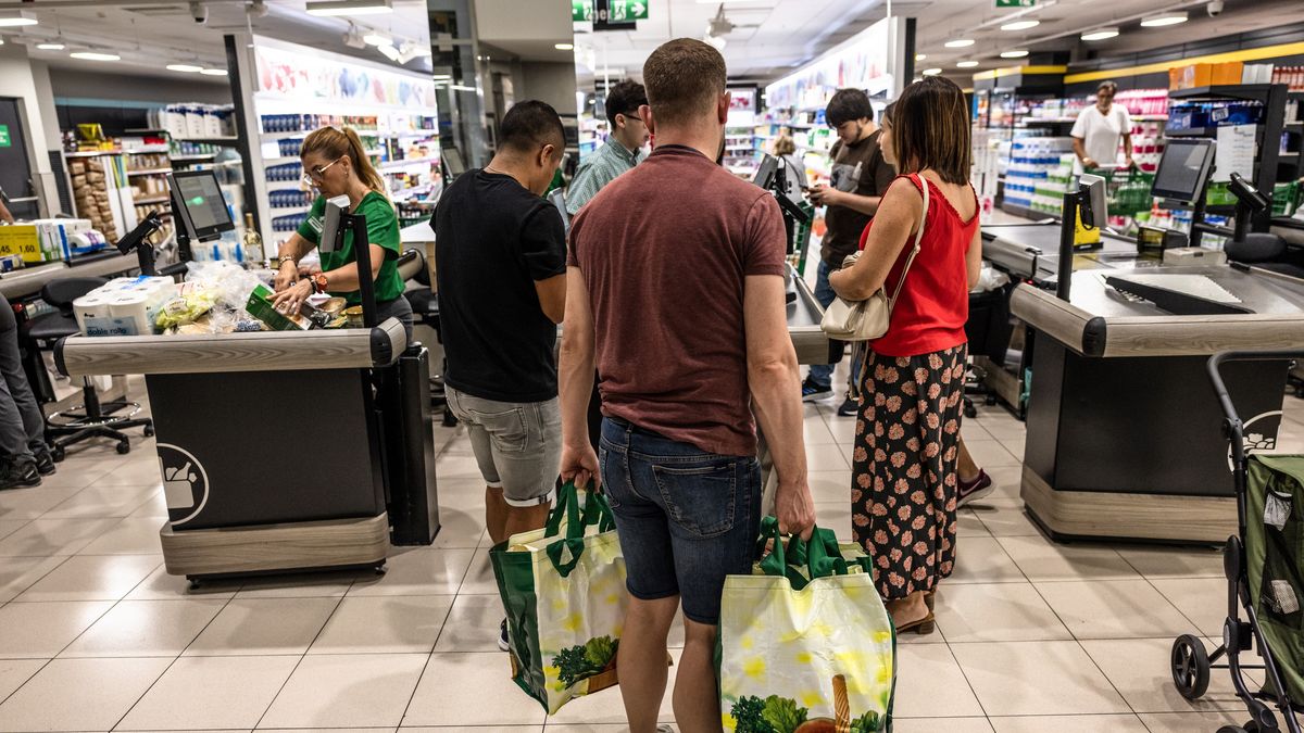 Customers with their shopping at the check-out counter of a Mercadona SA supermarket in Barcelona, Spain, on Thursday, Sept. 14, 2023. Bloomberg's monthly index, which calculates how much Spanish households need to spend on ingredients to make the Mediterranean rice dish paella, jumped 18.3% in August from a year ago, accelerating from a 15% rise the previous month. Photographer: Angel Garcia/Bloomberg via Getty Images