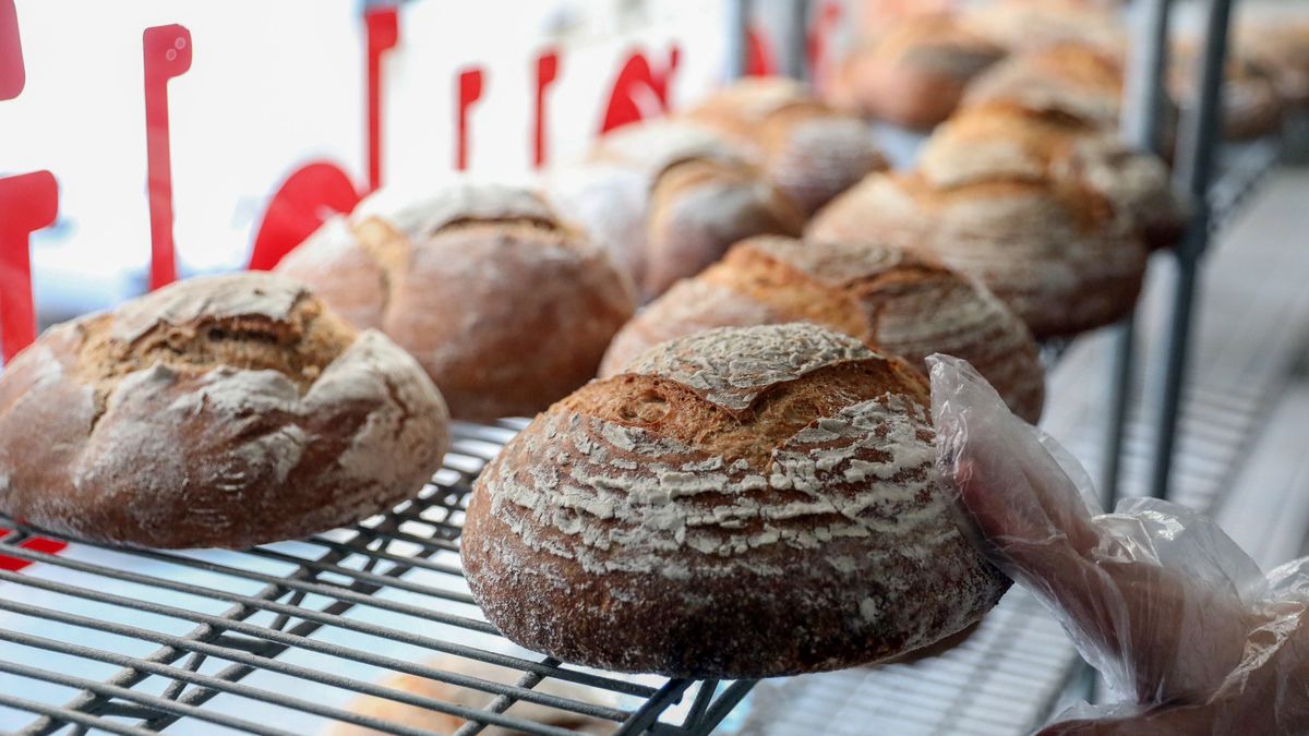 A worker selects a white bread loaf at a bakery in Beirut, Lebanon, on Thursday, March 31, 2022. Already gummed up by supply-chain bottlenecks, skyrocketing freight rates and weather events, markets are bracing for more upheavals as deliveries from Ukraine and Russia  which together account for about a quarter of the worlds grains trade  turn increasingly complicated and raise the specter of food shortages. Photographer: Hasan Shaaban/Bloomberg via Getty Images