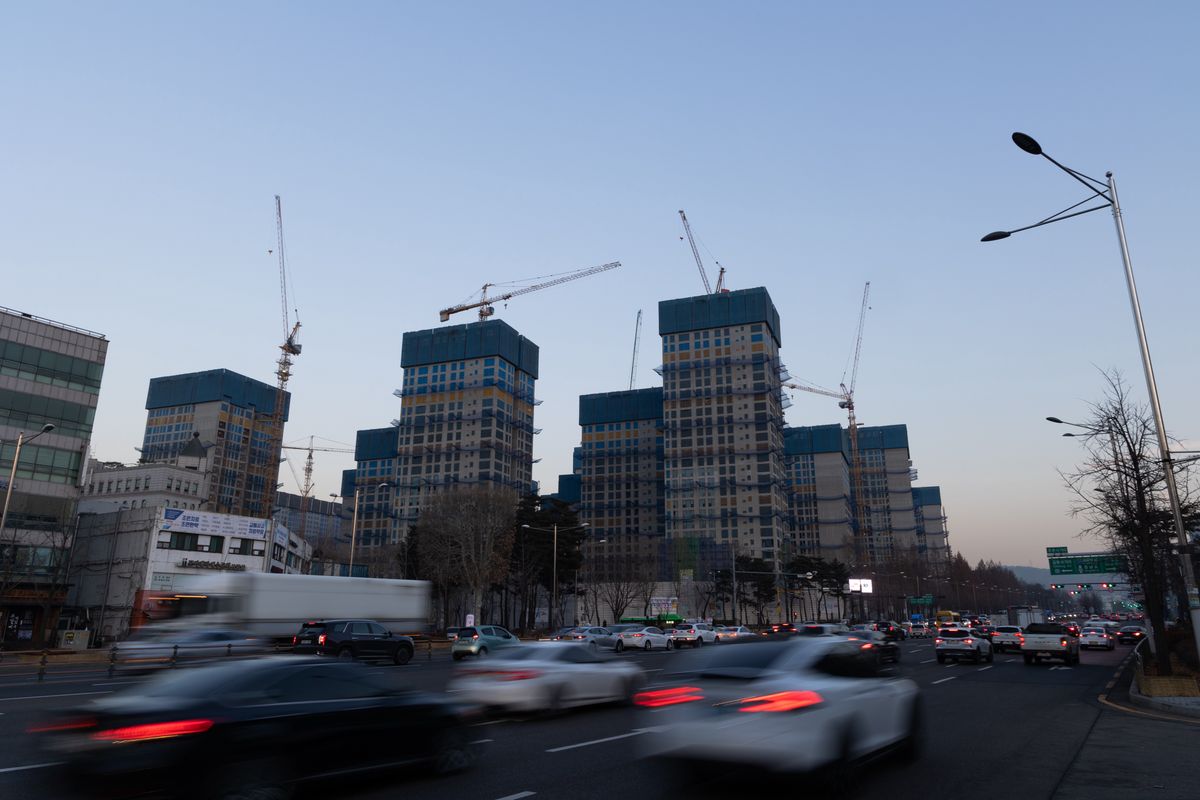 Vehicles drive past Olympic Park Foreon residential apartment buildings under construction in Seoul, South Korea. Photographer: SeongJoon Cho/Bloomberg via Getty Images