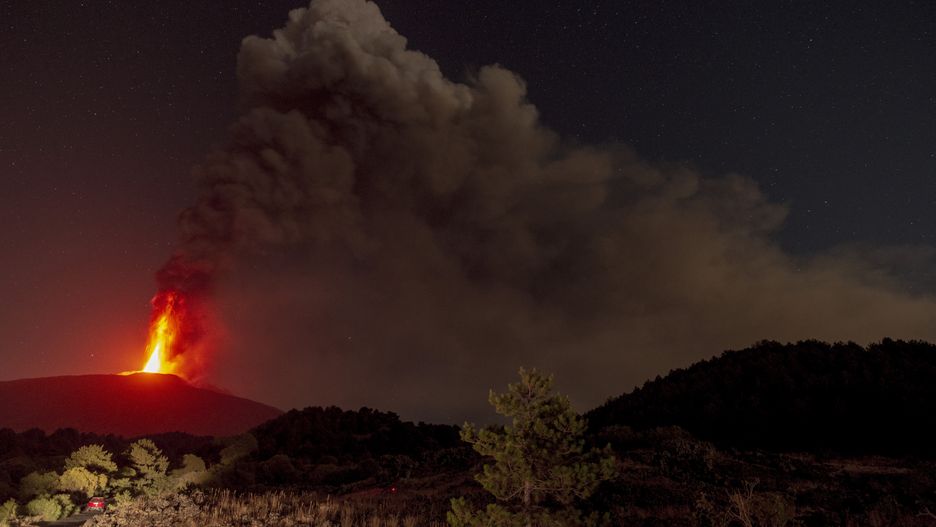 CATANIA, ITALY - JULY 16: A view of Mount Etna seen from Adrano, Catania producing a new eruption on July 16, 2024. From the late afternoon of 15 July until 03:00 on the night of 16 July, the activity was characterised by a lava fountain from the Voragine Crater that produced an eruptive column about 6000 m above sea level that propagated in an easterly direction with ash fallout in the towns of Viagrande and Acicastello until it was exhausted, a northwestern lava flow from the Bocca Nuova crater with the front at an altitude of about 3000 m above sea level. (Photo by Salvatore Allegra/Anadolu via Getty Images)