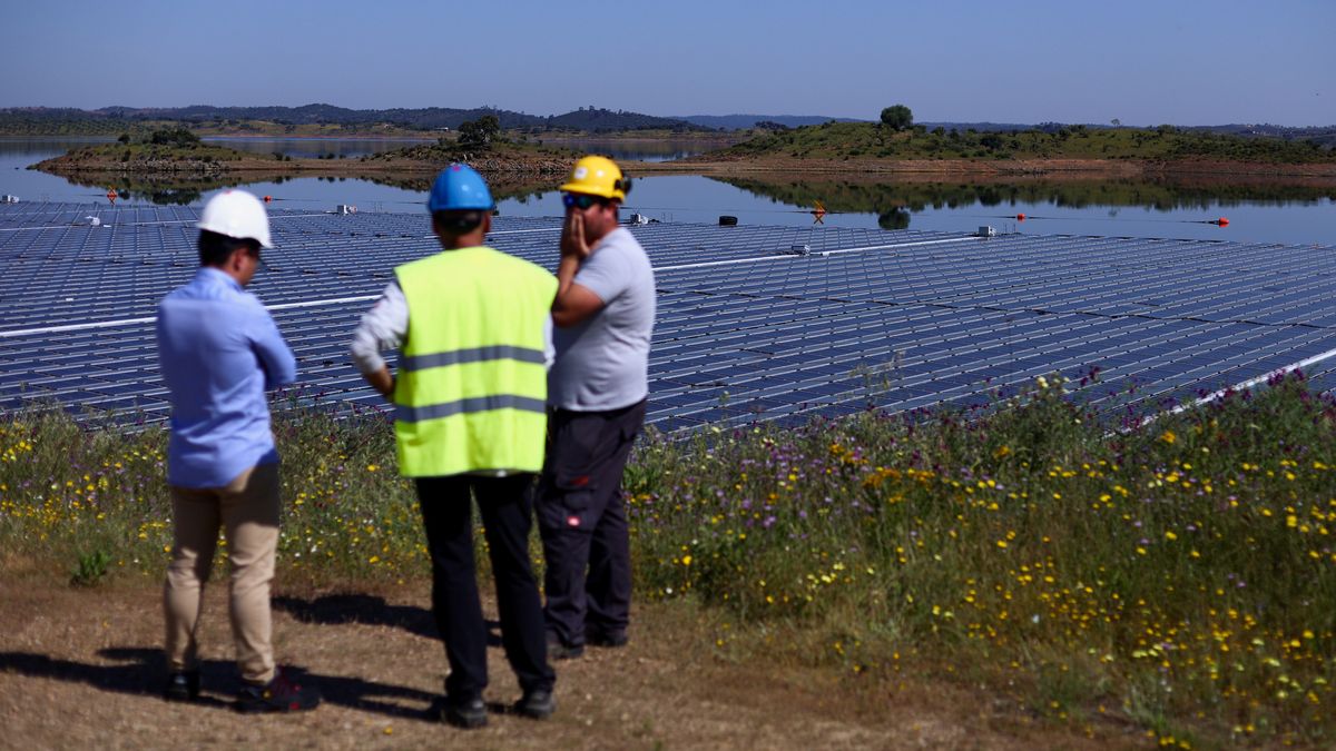 Workers talk during the installation of EDP's (Energias de Portugal) largest floating solar farm on a dam in Europe, on the surface of Alqueva dam, in Moura, Portugal, May 5, 2022. Picture taken May 5, 2022.