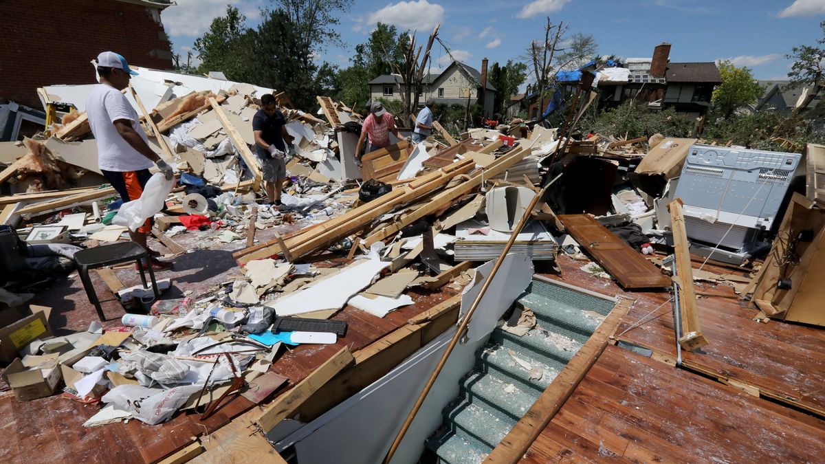 The stairwell leading to the basement and hardwood flooring is all that is left recognizable on June 22, 2021, following a tornado that hit DuPage County. (Antonio Perez/Chicago Tribune/Tribune News Service via Getty Images)