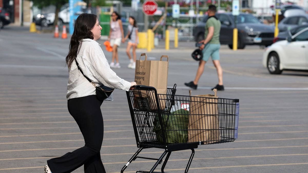 A shopper pushes a cart across a grocery store parking lot in Chicago on June 3, 2025. (Terrence Antonio James/Chicago Tribune/Tribune News Service via Getty Images)