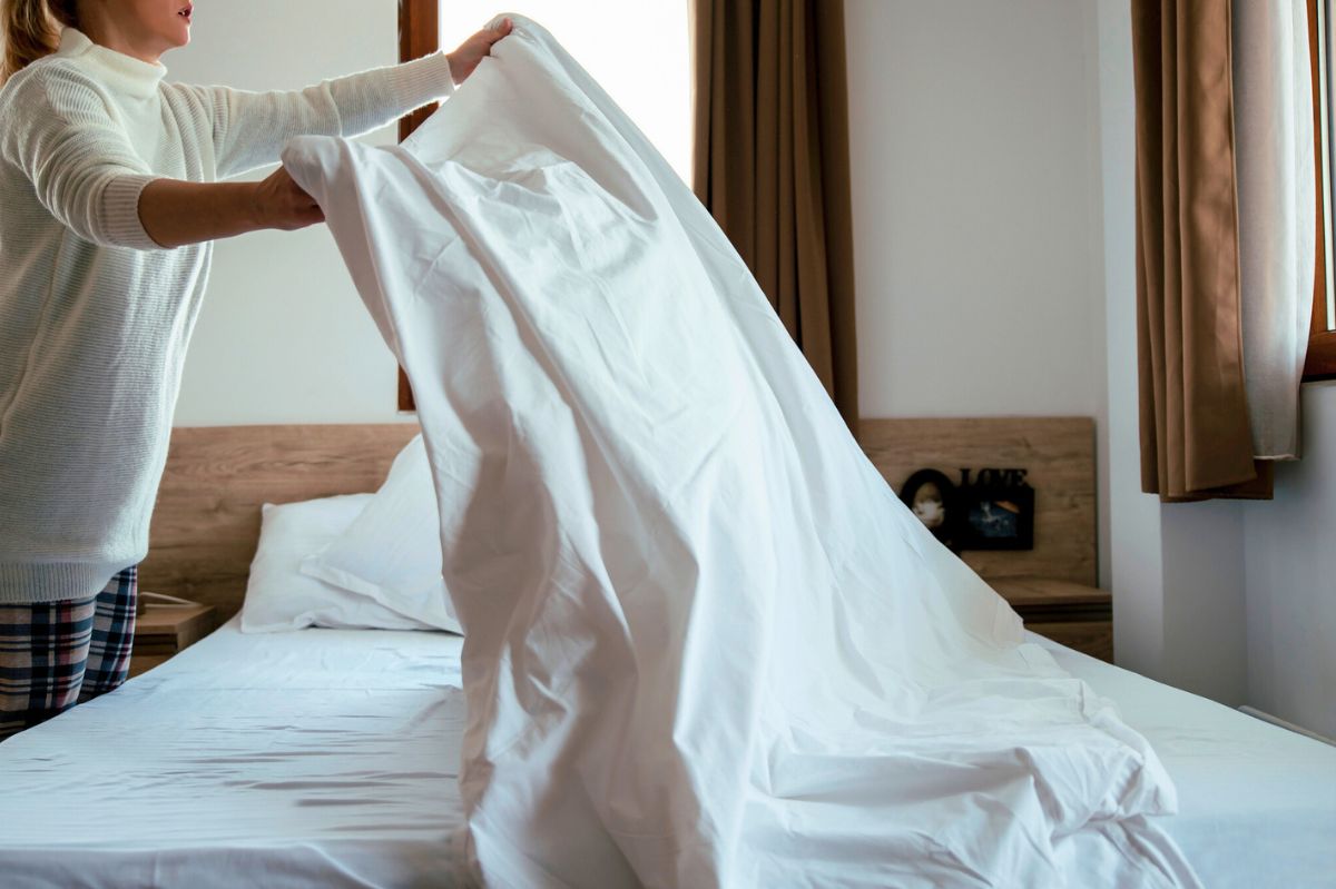 The woman changes the bedding.