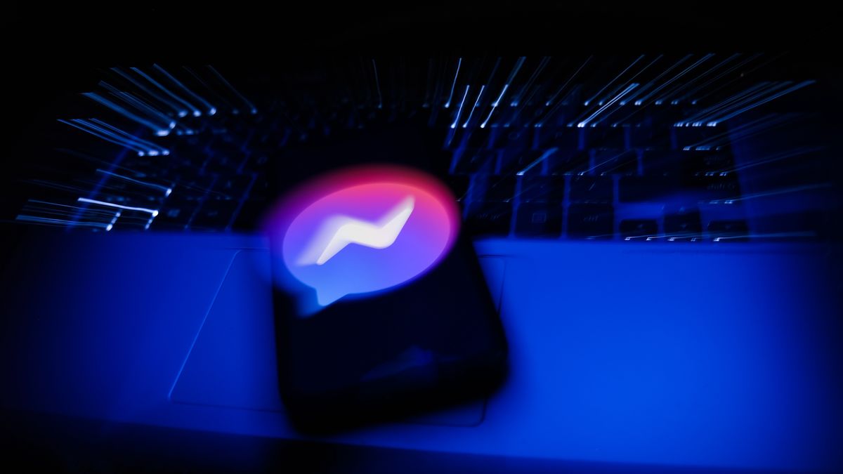 Messenger logo displayed on a phone screen and a laptop keyboard are seen in this long exposure illustration photo taken in Krakow, Poland on February 6, 2022. (Photo illustration by Jakub Porzycki/NurPhoto via Getty Images)