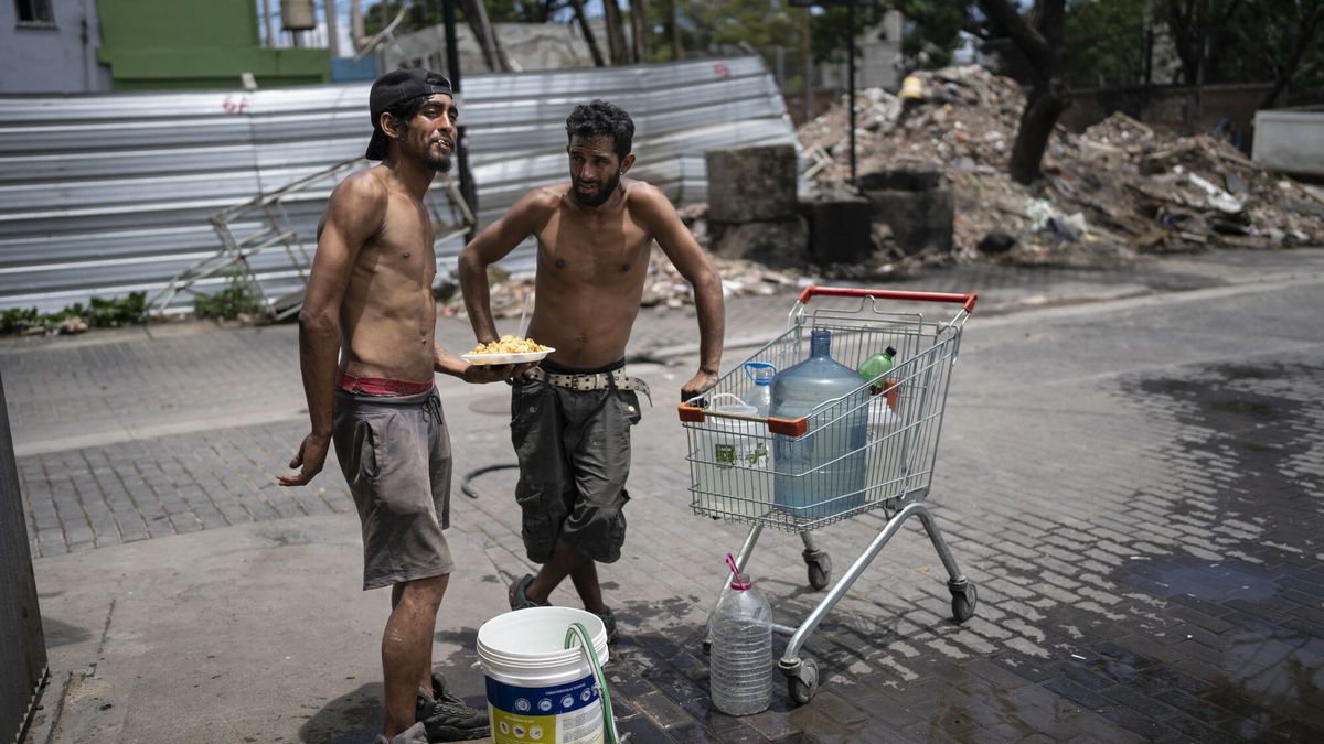 Temporary
Nicolas Gonzales, left, and Maxi Suarez fill containers with water from a street water source after getting food from the Casa Comunitaria del Fondo soup kitchen in the Padre Carlos Mugicain neighborhood of Buenos Aires, Argentina, Wednesday, Dec. 13, 2023. Argentina's government cut transportation and energy subsidies and devaluated the peso by 50% as part of shock measures new President Javier Milei says are needed to deal with an economic emergency. (AP Photo/Rodrigo Abd)
Rodrigo Abd