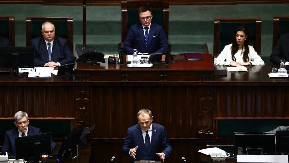 Marshal of Parliament Szymon Holownia and Leader of Civic Platform Donald Tusk delivers his programme speech as Prime Minister at Polish Parliament in Warsaw, Poland on December 12, 2023. (Photo by Jakub Porzycki/NurPhoto via Getty Images)