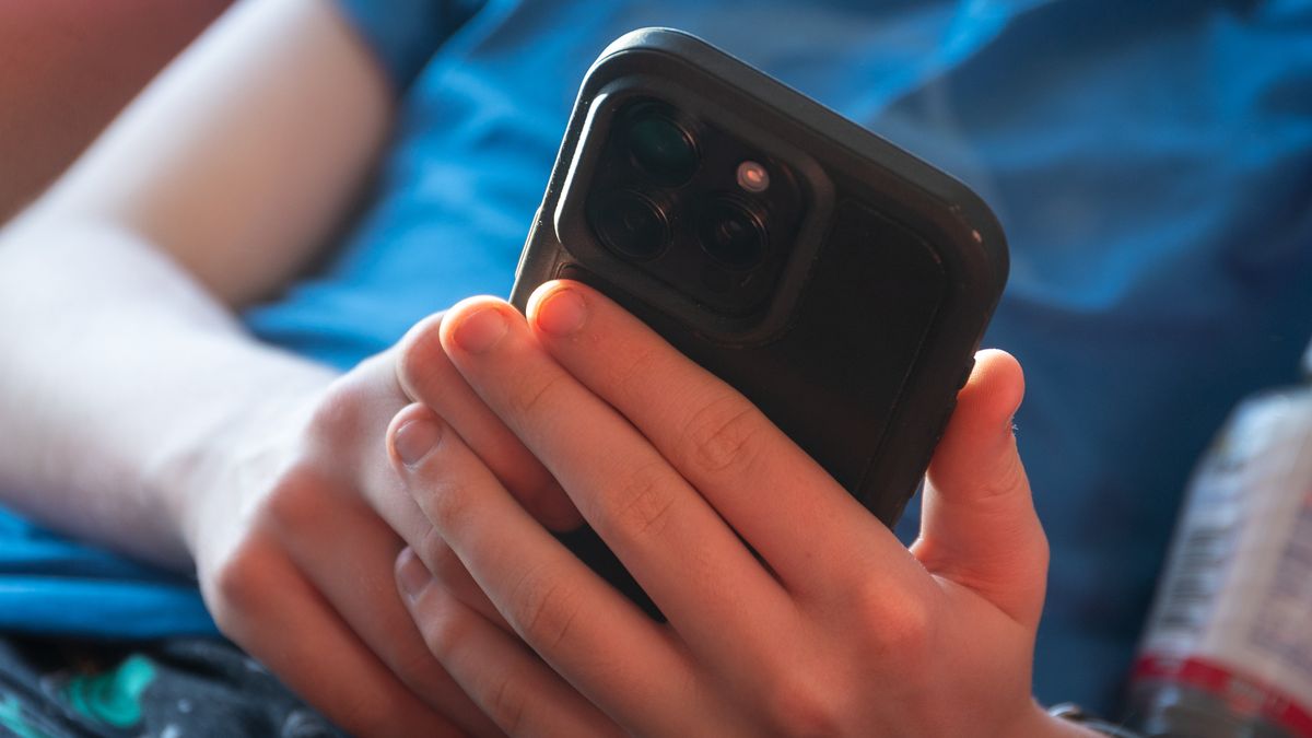 BATH, UNITED KINGDOM - NOVEMBER 30: A 14-year-old boy looks at a iPhone screen on November 30, 2024 in Bath, England. The Australian Senate passed a law to ban children under 16 from having social media accounts and social media platforms, including TikTok, Facebook, Snapchat, Reddit, X, formerly Twitter, and Instagram potentially being be fined for preventing children younger than 16 from having social media accounts. (Photo by Anna Barclay/Getty Images)