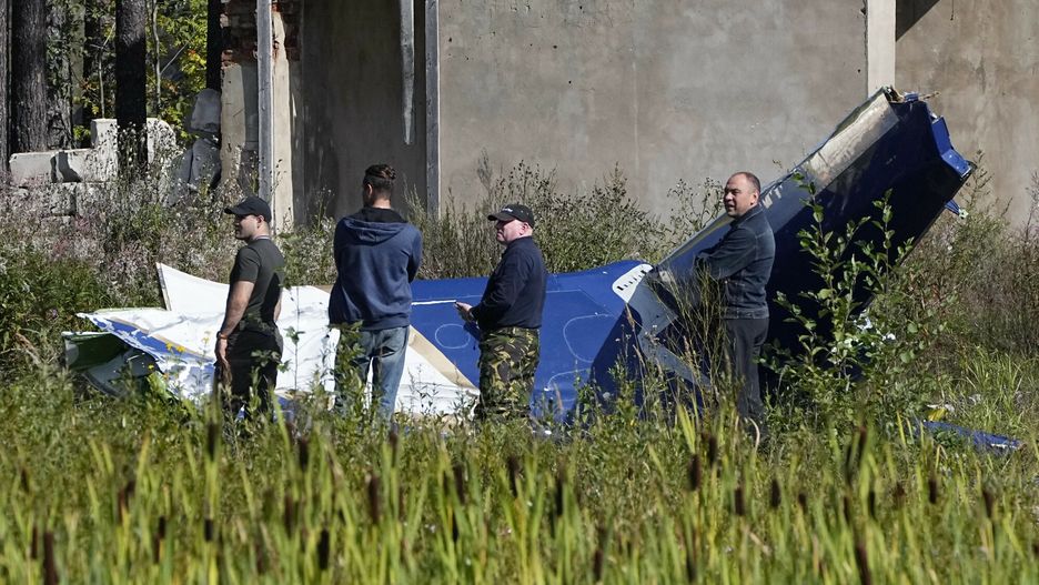 Rosyjscy żołnierze dokonują inspekcji części rozbitego prywatnego odrzutowca w pobliżu wsi Kuzhenkino w obwodzie twerskim