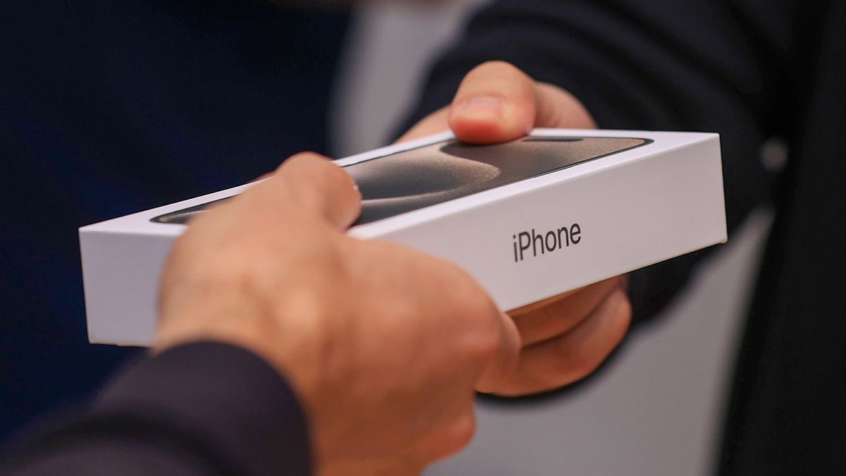 A customer with a iPhone 15 phone and other Apple products at the Apple Inc. Rosenthaler Strasse store in Berlin, Germany, on Friday, Sept. 22, 2023. Apple's latest iPhones and watches went on sale Friday, a test of whether a new smartphone design and modest smartwatch changes can help return the company to growth. Photographer: Krisztian Bocsi/Bloomberg via Getty Images