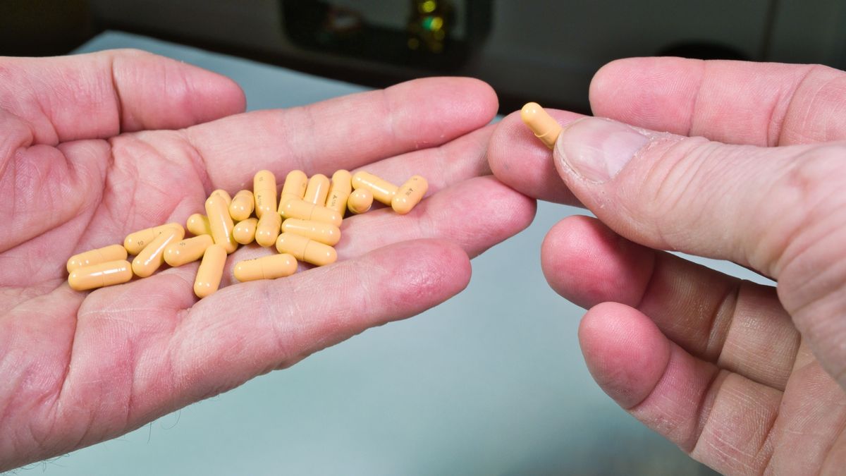 Pouring Yellow Capsules from Pill Bottle into Hand; Close-up of a person pouring tan/yellow capsules from an amber glass prescription bottle into the palm of their hand, representing medication or daily supplements.
Pouring Yellow Capsules from Pill Bottle into Hand; Close-up of a person pouring tan/yellow capsules from an amber glass prescription bottle into the palm of their hand, representing medication or daily supplements.
juan maria asensio garcia
chemicals, cure, healthcare, medical care, dosing, wellness, pharmacology, pharmaceutical, supplement, orange, treatment, fingers, overdose, pills, medical, daily dose, palm, synthetic, therapy, generic, taking, daily, sickness, medication, macro, prescription drug, capsules, health