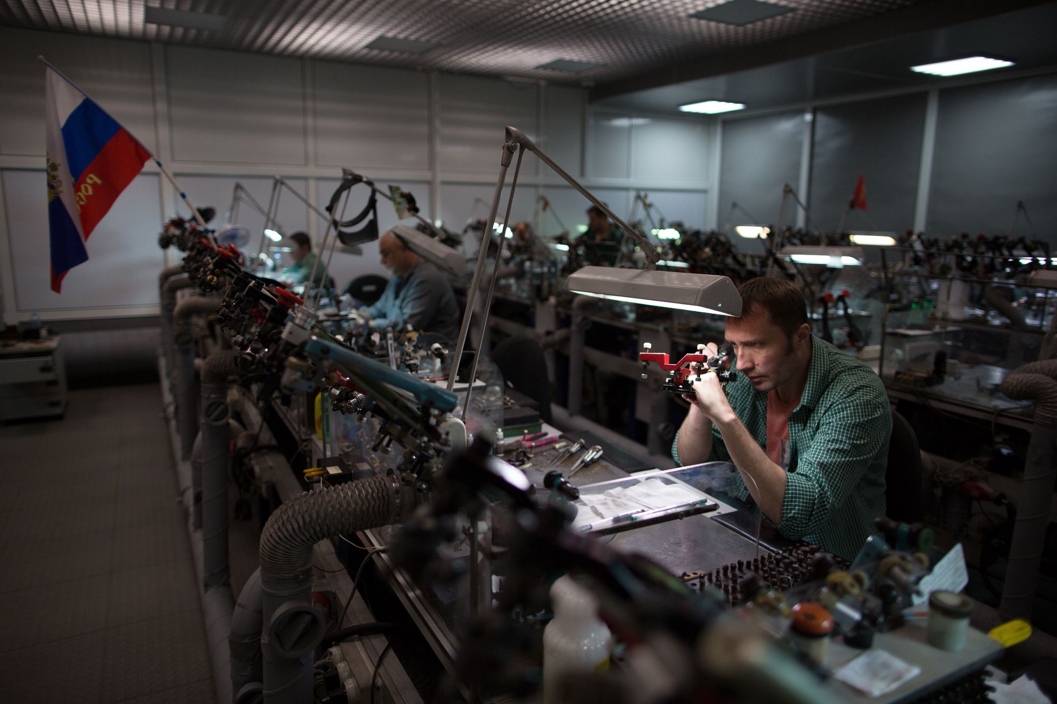 Luxury Diamonds At OAO Alrosa's Brilliantly Alrosa UnitA worker uses a magnifying glass to inspect a cut diamond at a workbench decorated with a Russian national flag at OAO Alrosa's cutting and polishing unit, Brilliantly Alrosa, in Moscow, Russia, on Thursday, May 25, 2017. Alrosa is the worlds second-biggest diamond miner. Photographer: Andrey Rudakov/Bloomberg via Getty ImagesBloombergEAME, EMEA