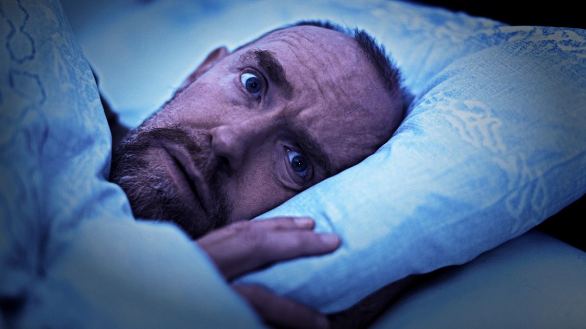 Mature man lying in bed, wide awake, looks worried and scared
A mature man lies in bed, eyes wide open, looking scared and as though in the throes of a full-blown panic attack.
RapidEye