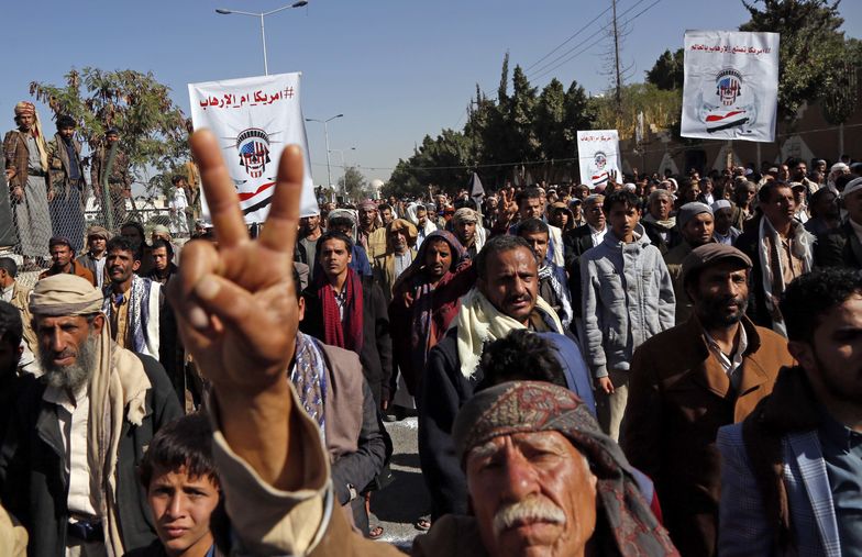 SANAA, YEMEN - JANUARY 18: Supporters of Yemen's Huthi movement stage a demonstration in front of the closed US Embassy in the capital Sanaa on January 18, 2021, to reject outgoing US President Donald Trump's decision to designate the Huthi group a "foreign terrorist organisation". - Impoverished Yemen is mired in a devastating conflict between Iran-backed Huthi rebels and government forces backed by Saudi Arabia that has left tens of thousands dead and sparked a dire humanitarian crisis. (Photo by Mohammed Hamoud/Anadolu Agency via Getty Images)